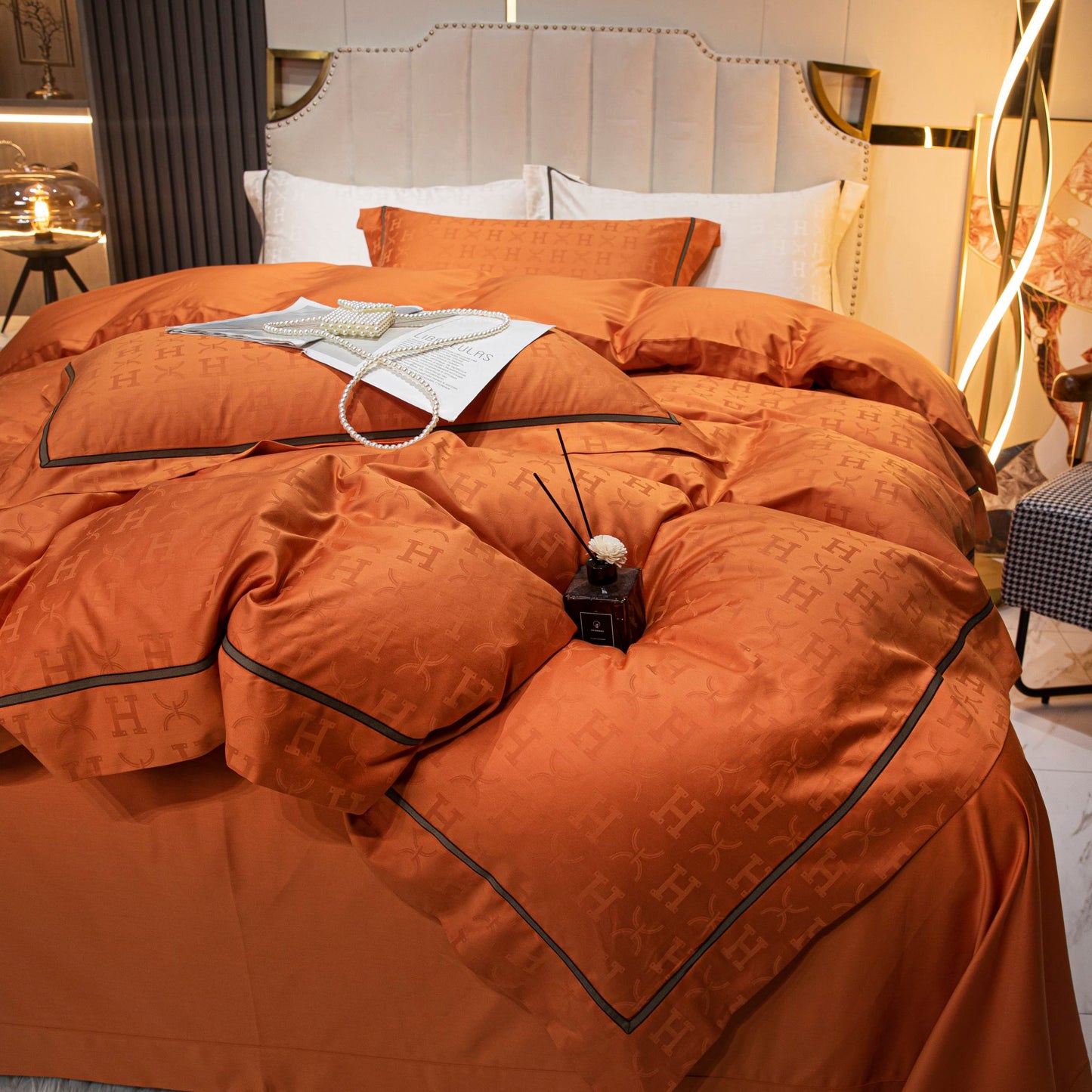 Luxurious tangerine sateen bedding set made from soft breathable Tencel cotton with elegant black trim detailing.