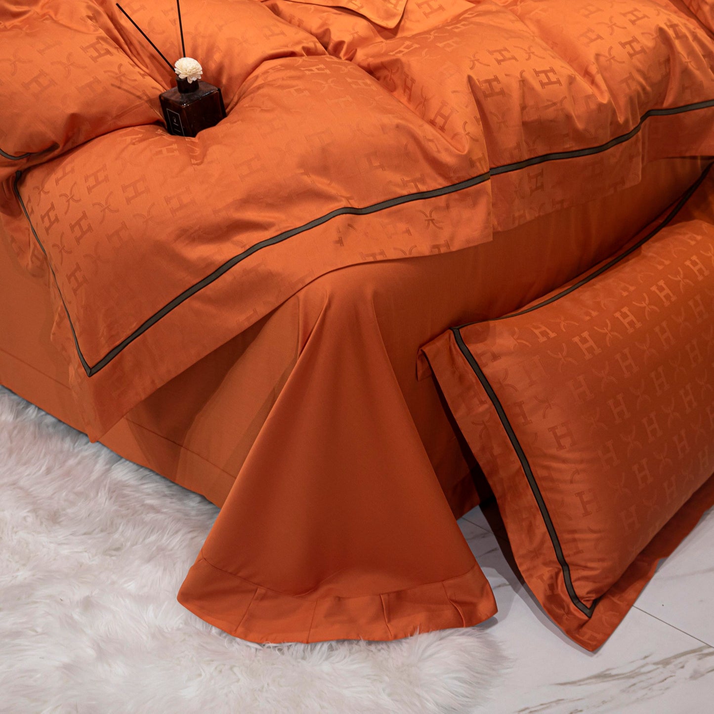 Luxurious tangerine sateen bedding set with subtle pattern, made from soft breathable Tencel cotton for elegant comfort.