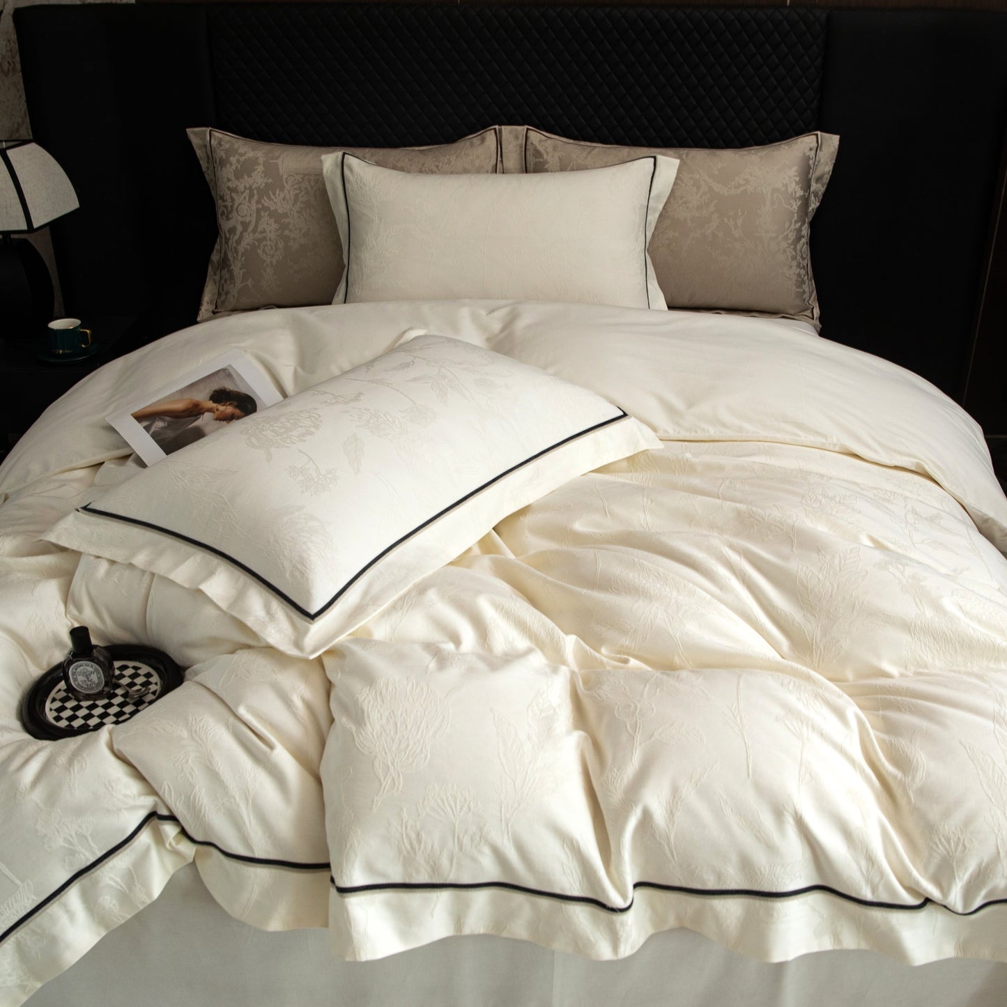 Luxurious Paris sateen bedding set in soft cream with subtle patterns and black trim, made from breathable Tencel cotton.