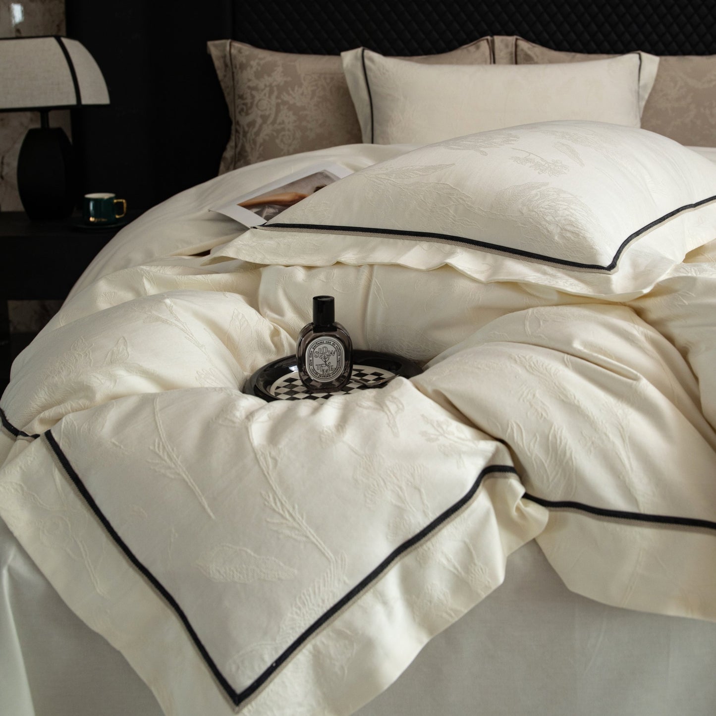 Luxurious cream sateen bedding set with black piping detail, made from soft breathable Tencel cotton for elegant comfort.