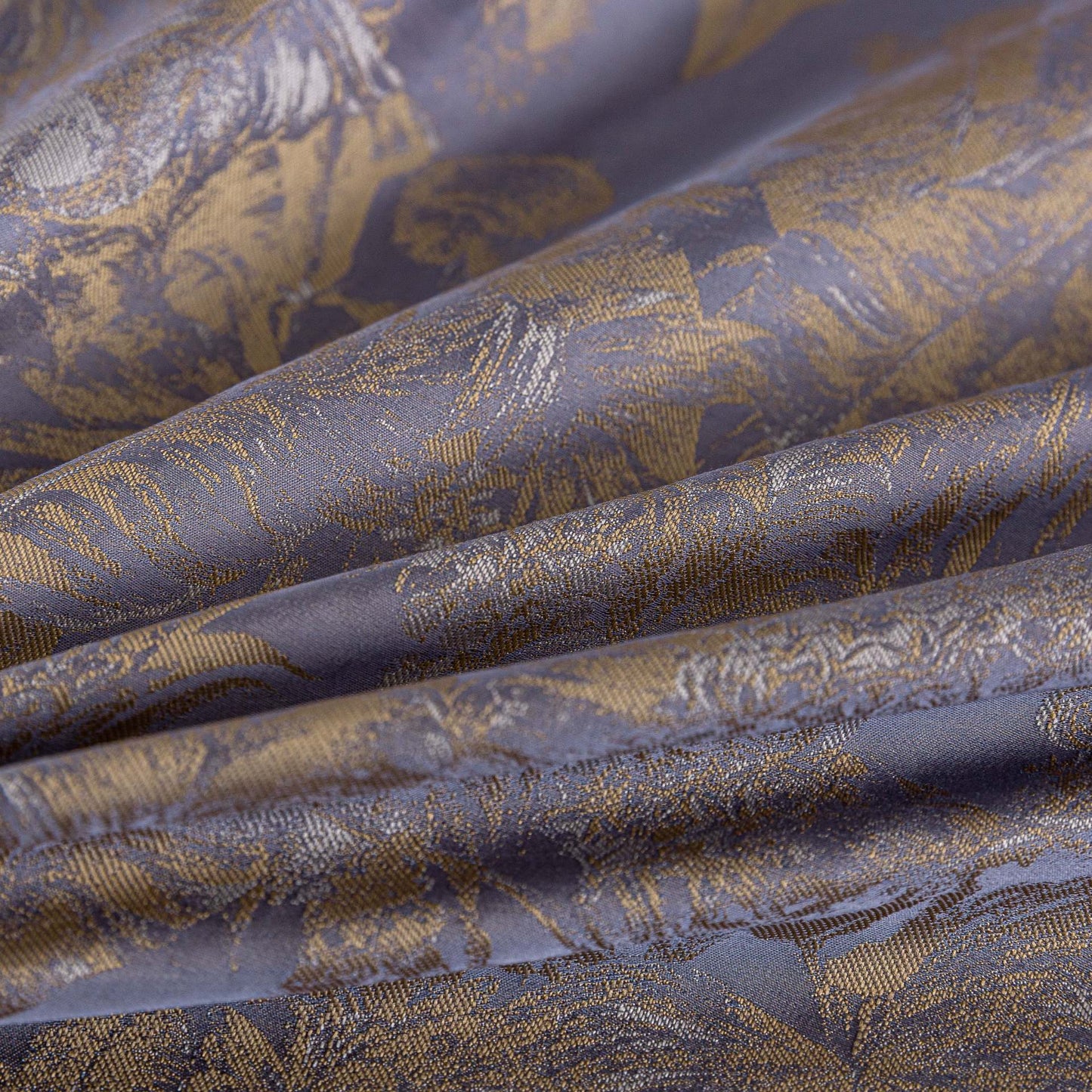 Close-up of luxurious purple and gold sateen bedding fabric with intricate floral pattern and smooth texture