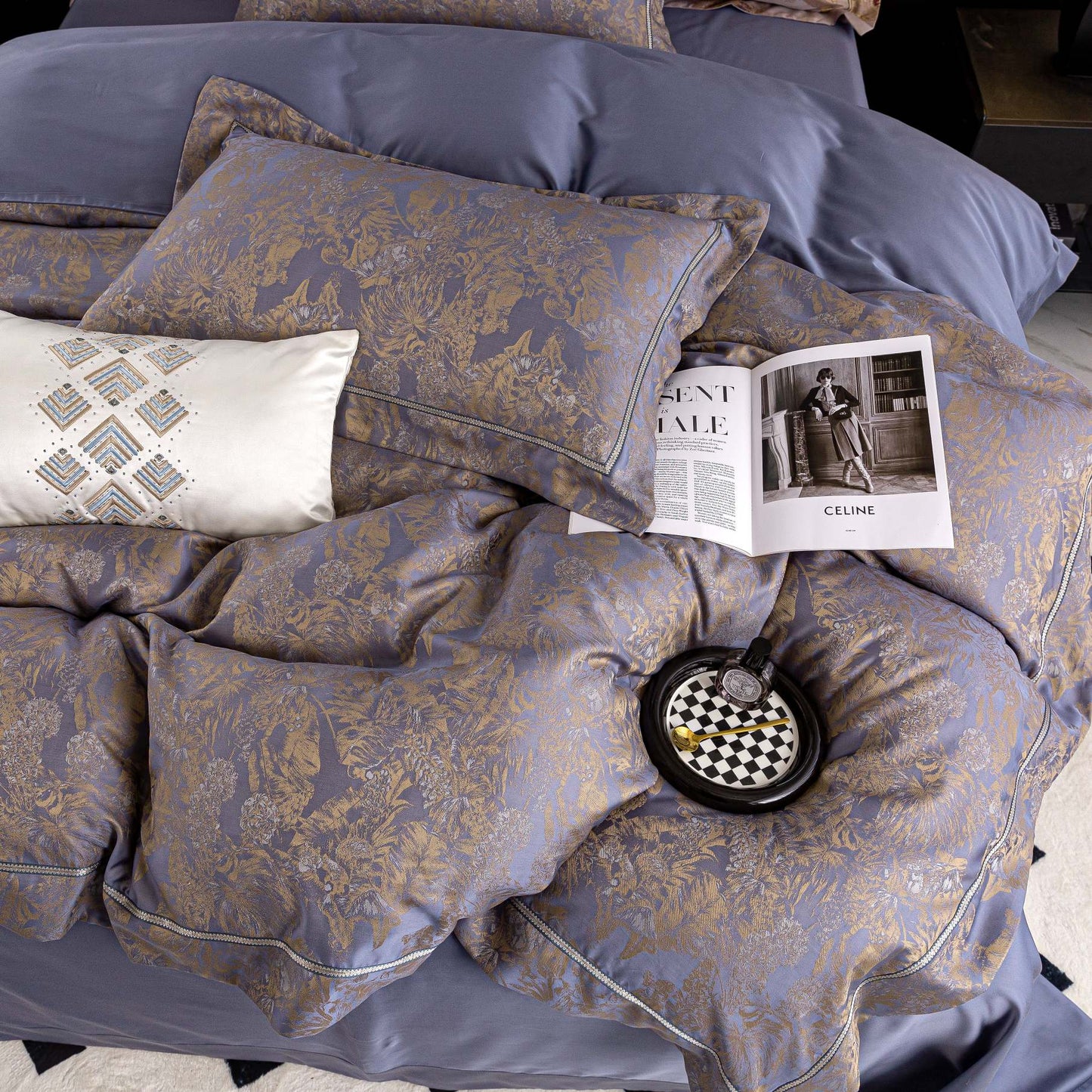 Luxurious Versailles sateen bedding set in soft blue and gold tones with intricate floral patterns and smooth Tencel cotton texture.