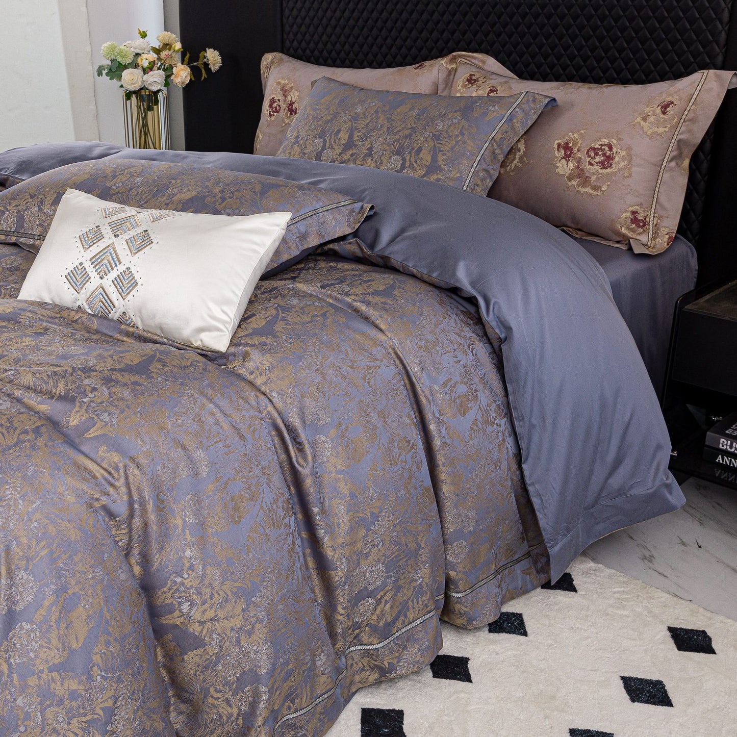Luxurious Versailles sateen bedding set in muted tones with intricate patterns, featuring duvet cover, sheets, and pillowcases.