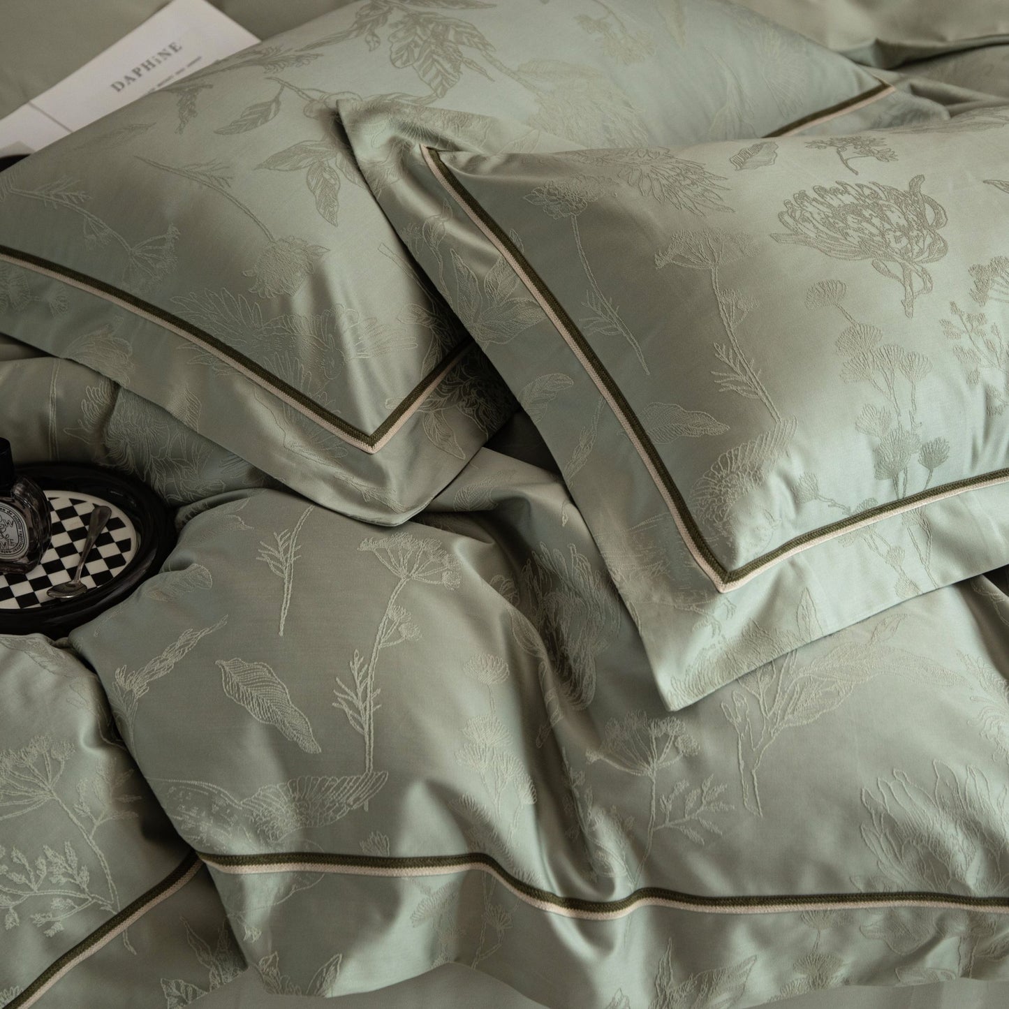 Luxurious Avignon sateen bedding set in soft green with subtle floral jacquard and elegant piping details.