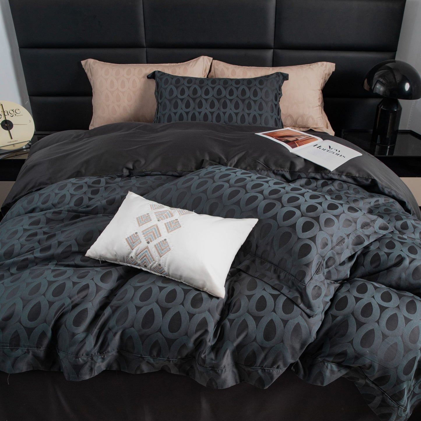 Luxurious Brooklyn sateen bedding set in charcoal with modern geometric pattern and soft beige accent pillows on bed