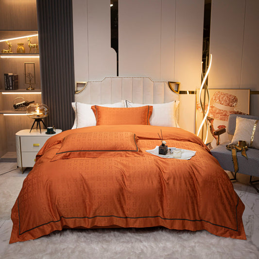 Luxurious orange sateen bedding set with duvet cover, pillowcases, and bed sheet in a modern stylish bedroom setting.