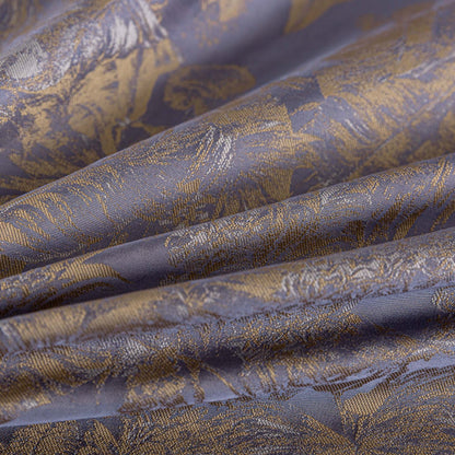 Close-up of luxurious purple and gold sateen bedding fabric with intricate floral pattern and smooth texture