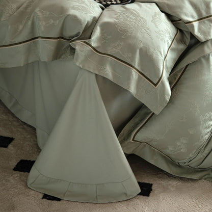Luxurious Avignon sateen bedding set in soft muted tones with detailed embroidery on pillowcases and duvet cover.