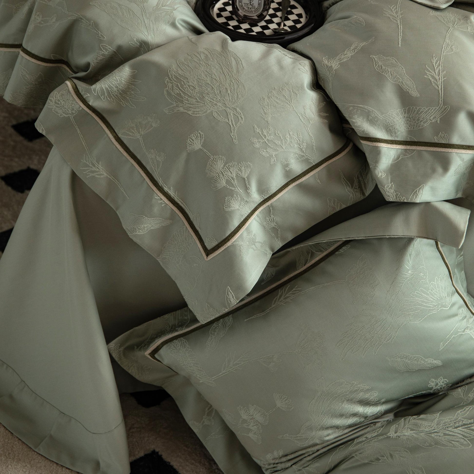 Luxurious Avignon sateen bedding set in soft green with botanical embroidery and smooth Tencel cotton fabric.