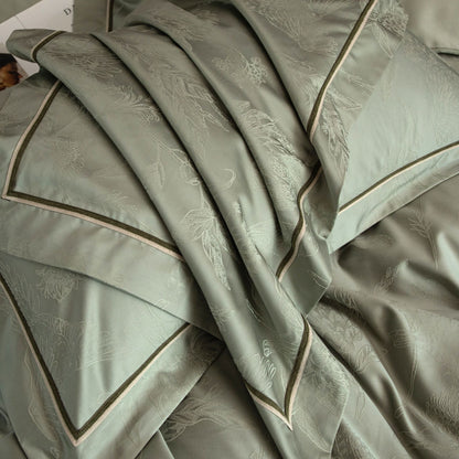 Luxurious Avignon sateen bedding set in soft green with subtle floral jacquard and contrasting trim detail.