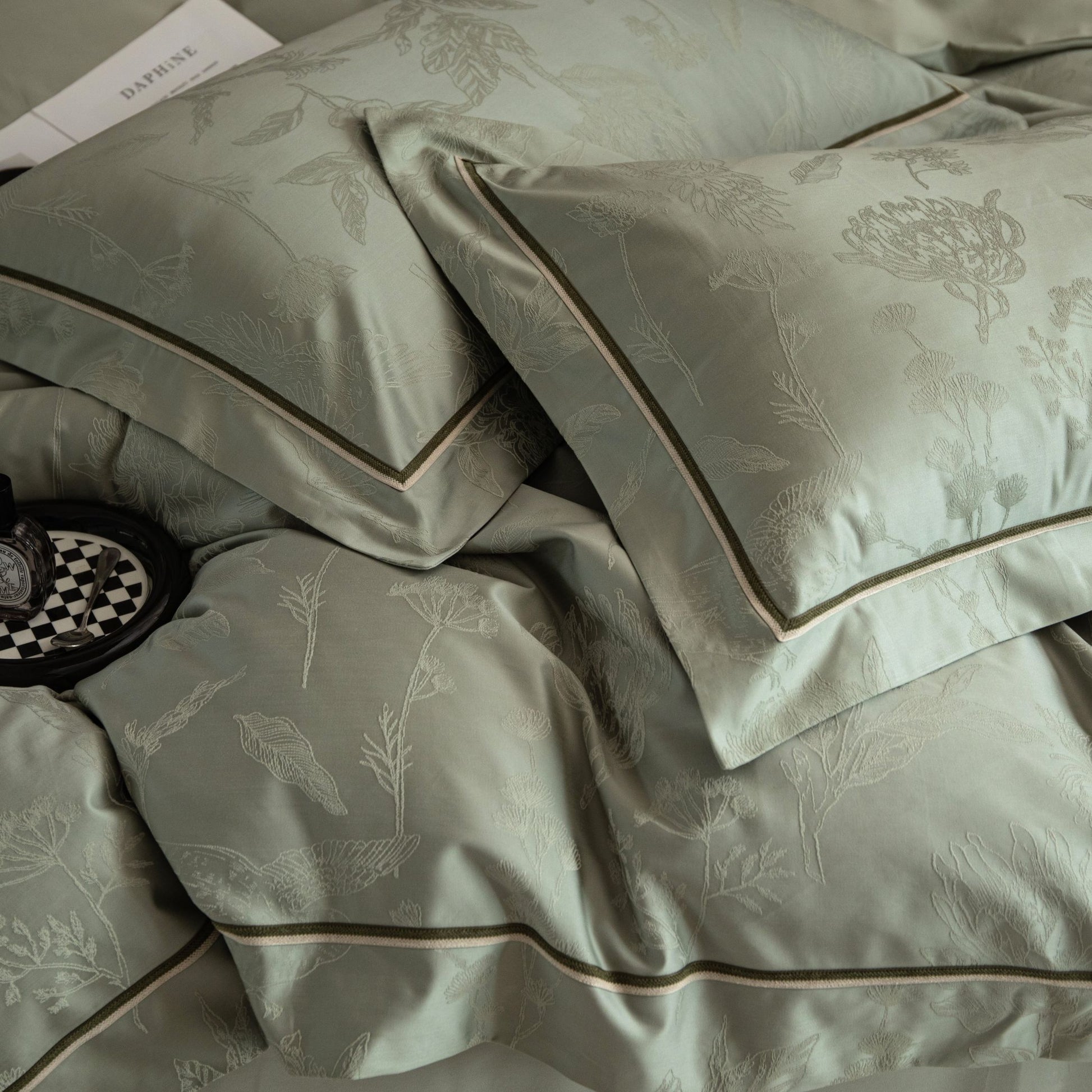 Luxurious Avignon sateen bedding set in soft green with subtle floral jacquard and elegant piping details.
