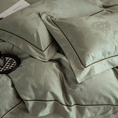 Luxurious Avignon sateen bedding set in soft green with subtle floral jacquard and elegant piping details.