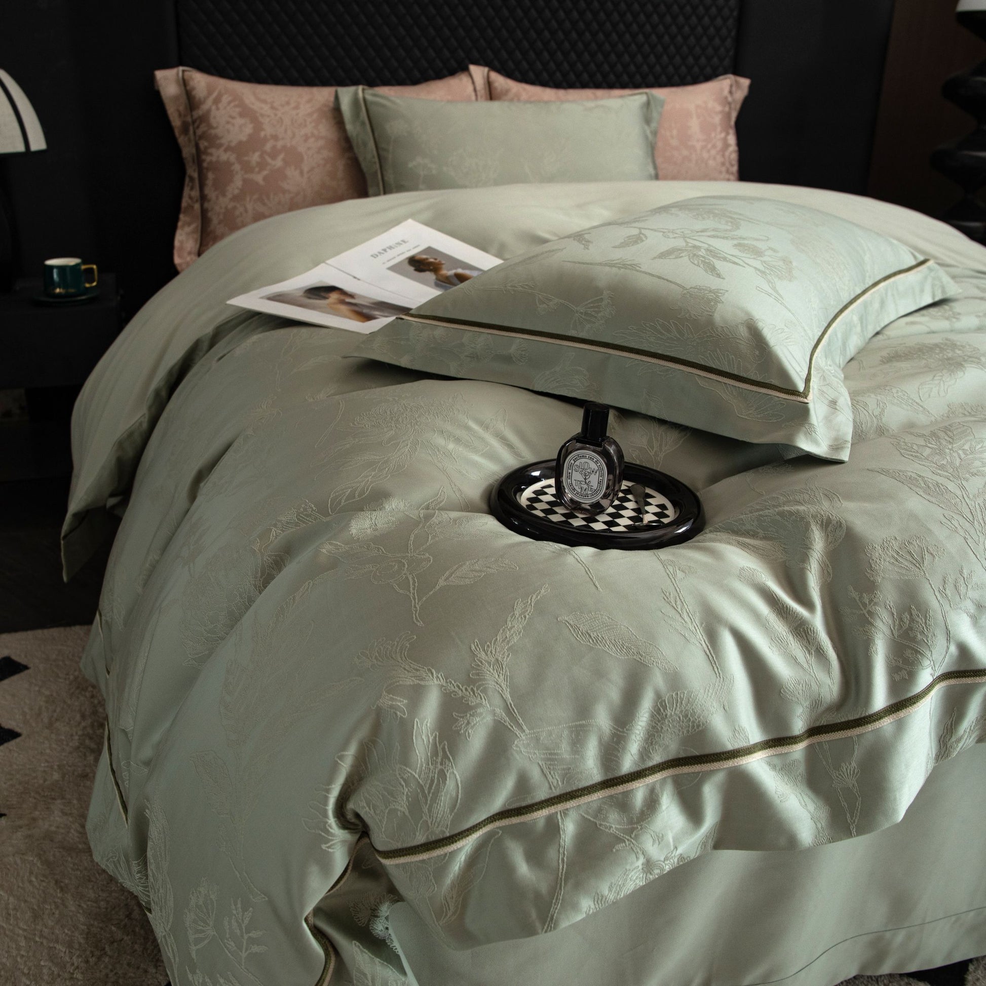 Luxurious Avignon sateen bedding set in soft green with delicate floral patterns and smooth silky texture on a modern bed.