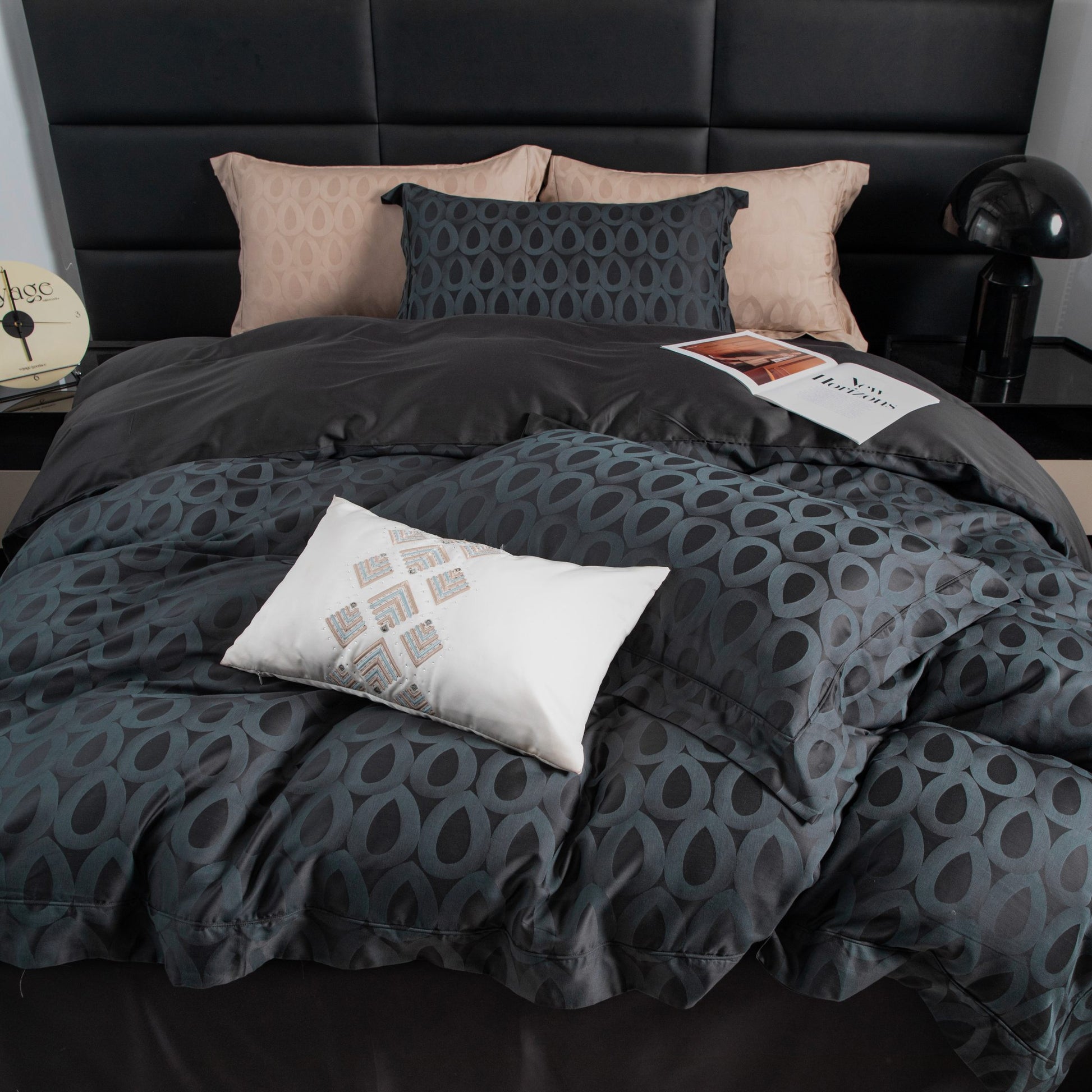 Luxurious Brooklyn sateen bedding set in charcoal with modern geometric pattern and soft beige accent pillows on bed