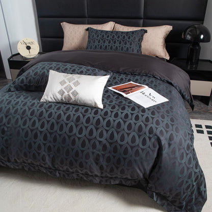 Modern geometric sateen bedding set in deep charcoal with soft beige and slate grey pillowcases on a styled bed.