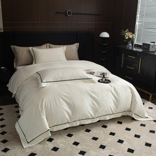 Luxurious soft cream sateen bedding set with black trim on modern bed in elegant dark bedroom setting