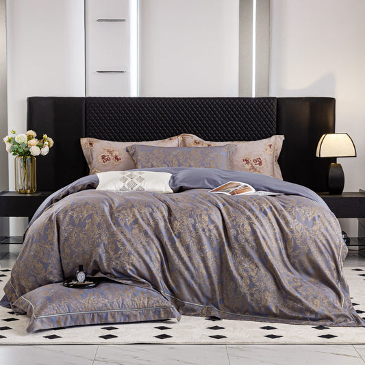 Luxurious Versailles sateen bedding set in elegant blue and gold tones on modern black upholstered bed.